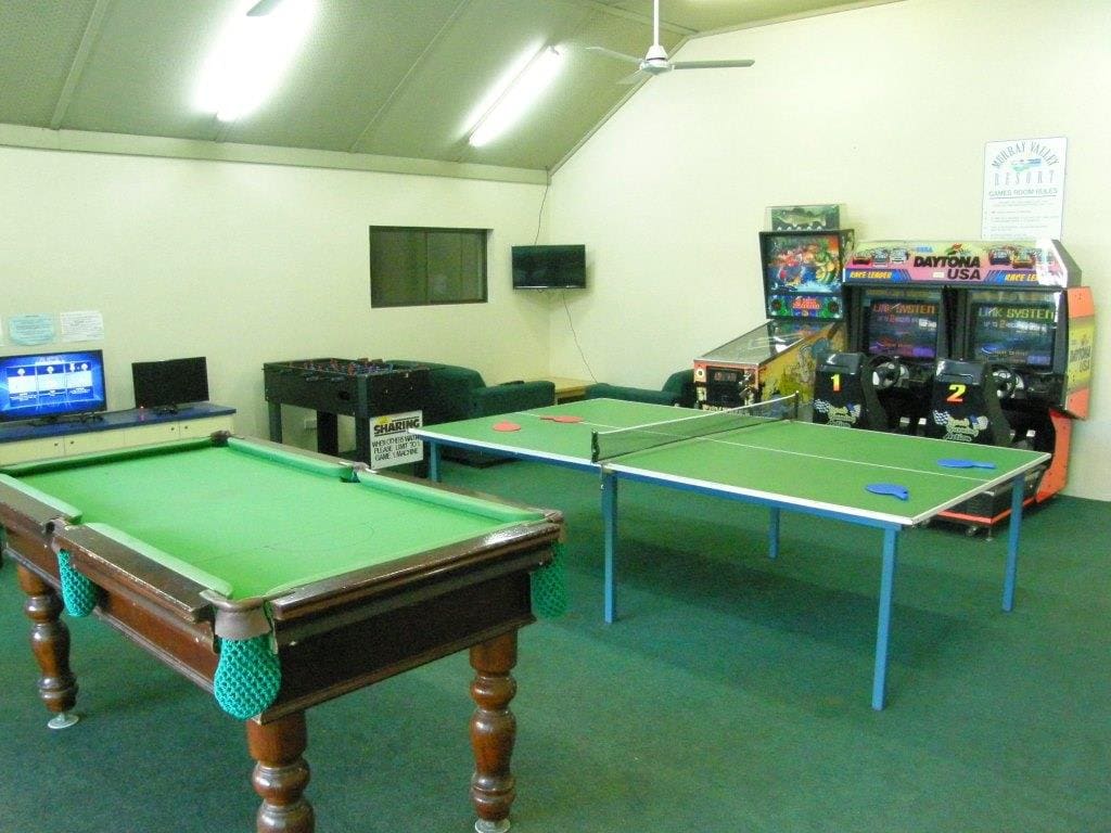 Games room with a pool table, table tennis table and arcade machines