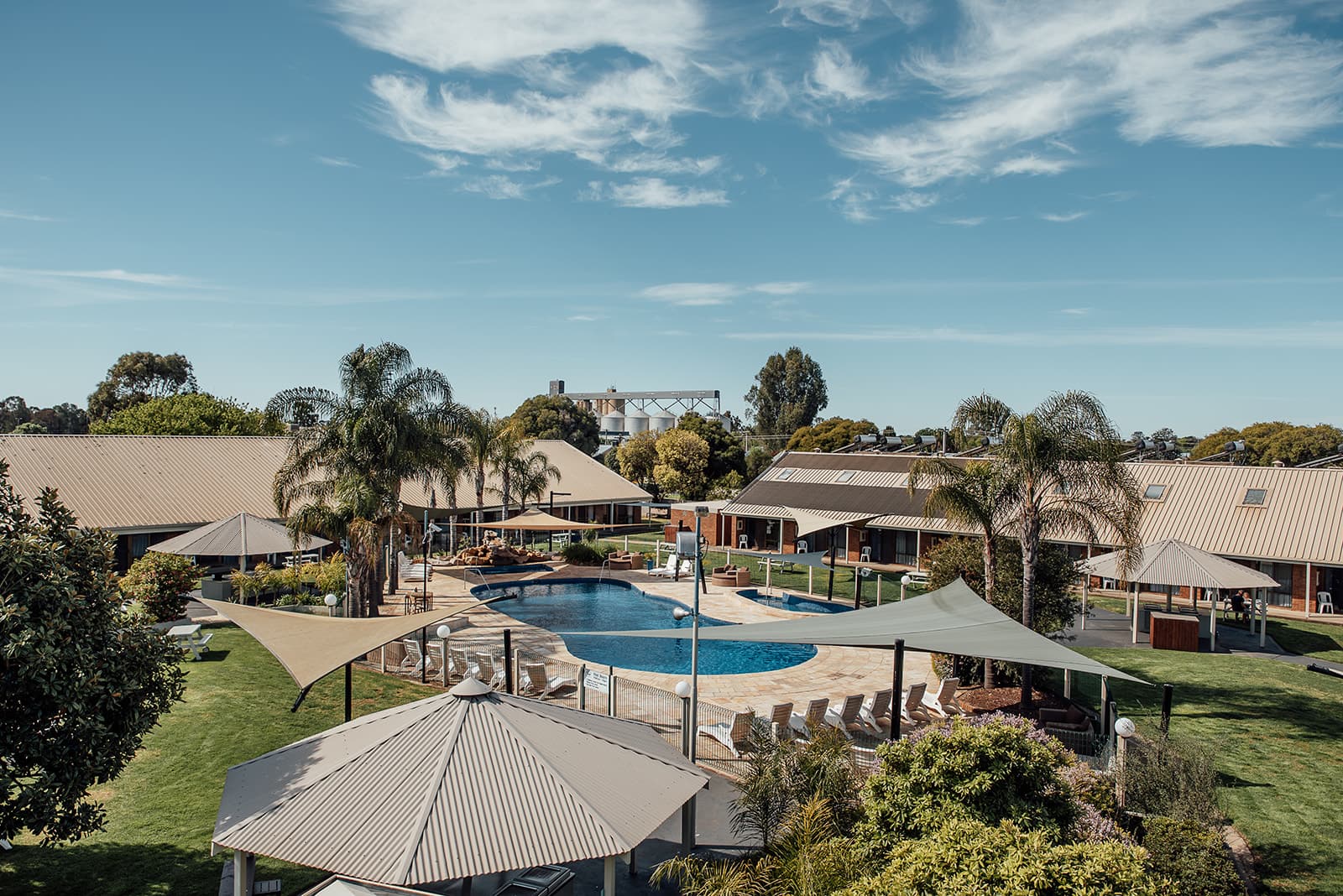 Elevated view of the resort grounds, pool and shade sails