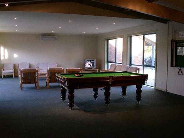 Lounge room with a full-size billiard table and armchairs